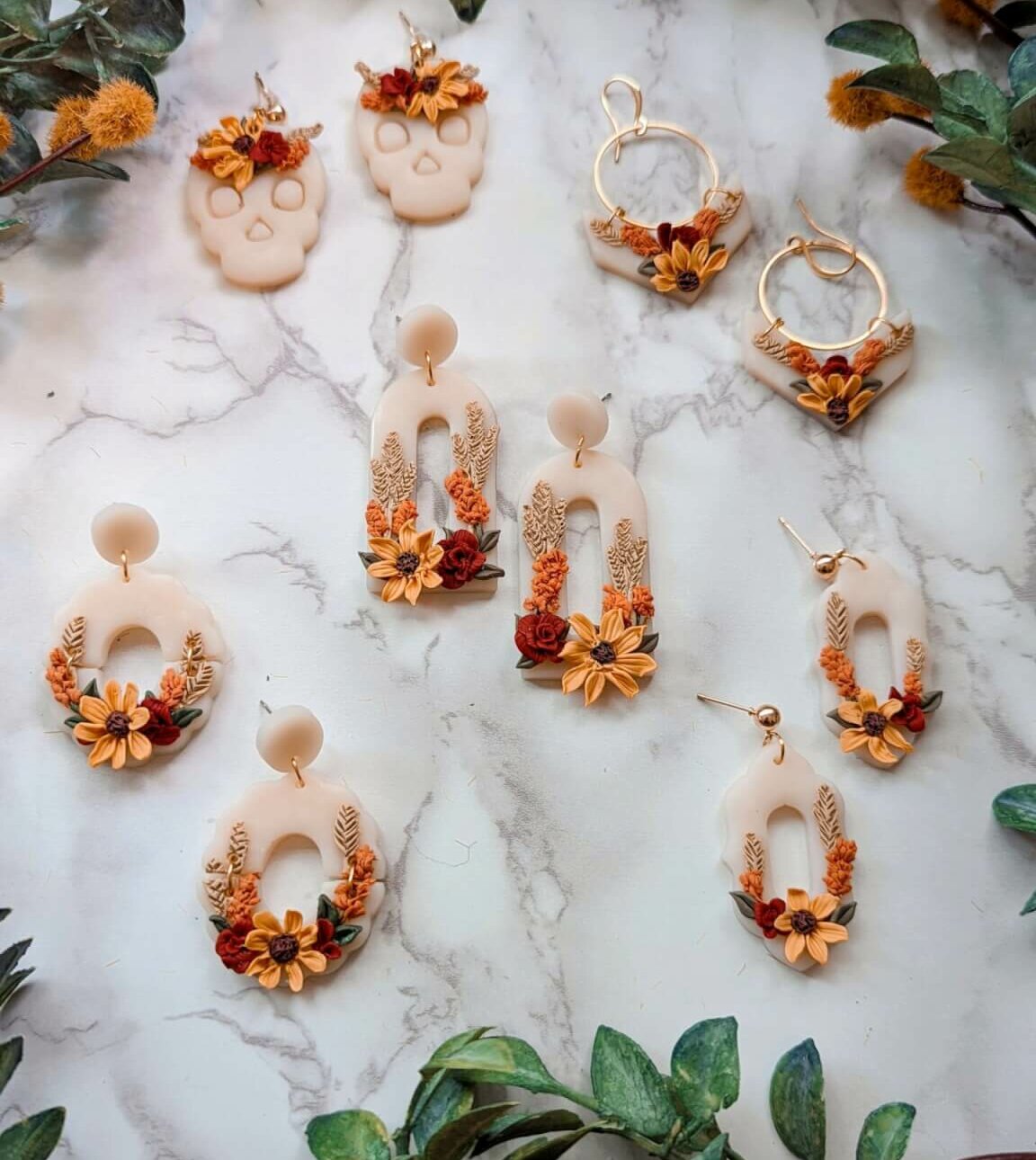 Earrings made of clay with fall flowers on them.