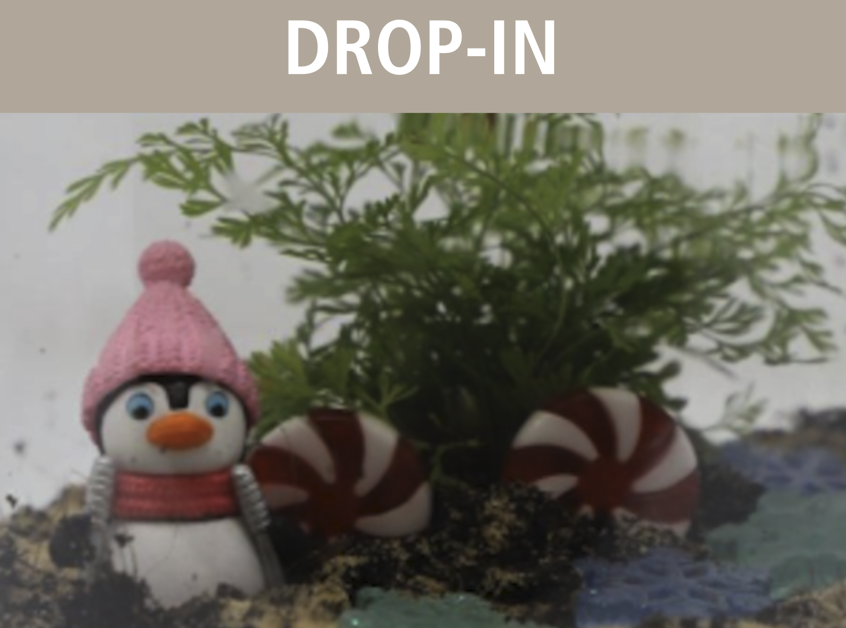 Tropical snow globe terrarium with penguin and plants.